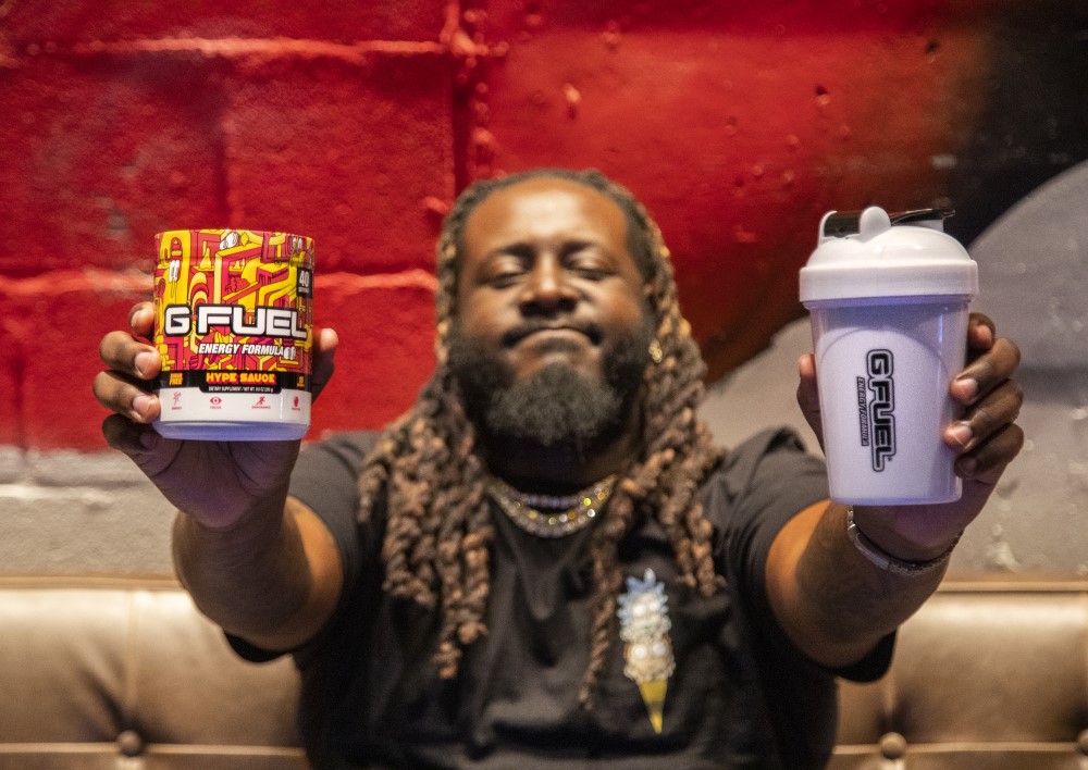 t-pain holding a g fuel hype sauce tub and hype sauce shaker cup